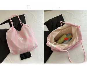 Detail of pink tie-dye mesh tote bag showing large capacity with floral 3D decorations