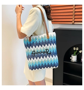 Detail of summer woven tote bag with blue and green wavy pattern and SUMMER embroidery