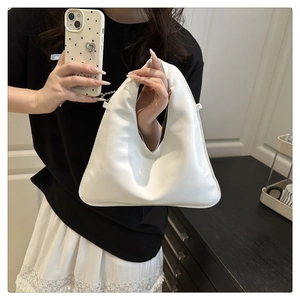 Detailed close-up of textured white PU leather on this minimalist handheld tote bag
