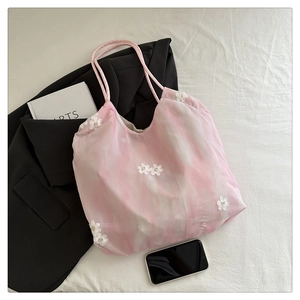 Detail of pink tie-dye tote bag with 3D lace flower embroidery and rope handle