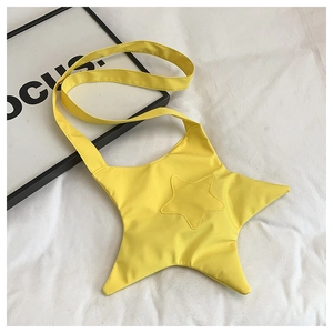 Detailed top view of a bright yellow star-shaped canvas crossbody bag on white background