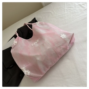Detailed view of pink tie-dye camisole with 3D floral embroidery and pearl accents