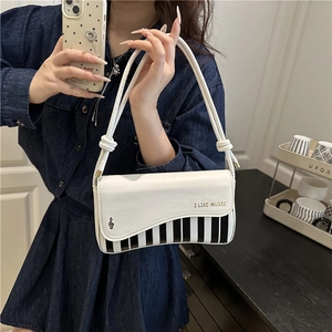 Piano key themed crossbody bag with I LIKE MUSIC lettering and musical note design