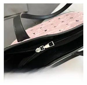 Detail showing high-quality silver metal zipper and cute rabbit print on pink tote bag