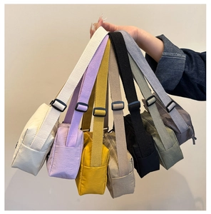 Close-up of lightweight nylon crossbody bags in seven vibrant colors for fitness