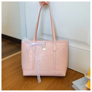 Detail of pink faux leather tote with embossed poodle patterns and white lace bow