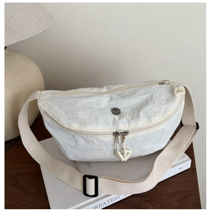 Detail of white crescent nylon chest bag showing smooth zippers and woven strap