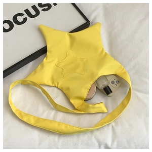 Star-shaped yellow canvas crossbody bag showing interior storage capacity and cosmetics