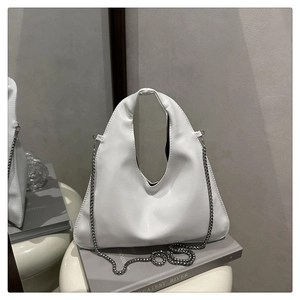 Detail of white leather half-moon bag featuring silver beaded chain and seamless handle
