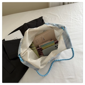 Detail view of large canvas tote bag showing spacious interior and woven rope handles