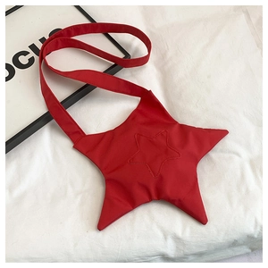 Detailed view of red star-shaped crossbody bag with quilted nylon fabric and strap
