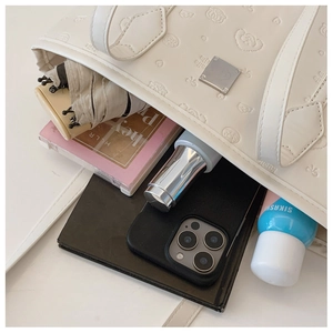 Top view of white leather tote bag interior showing large capacity for daily items