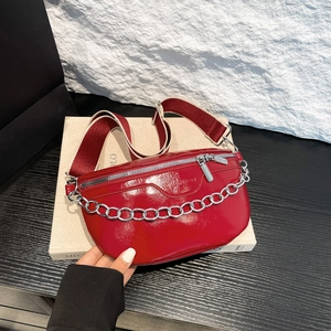 Glossy red crossbody waist bag with thick silver chain detail and wide strap