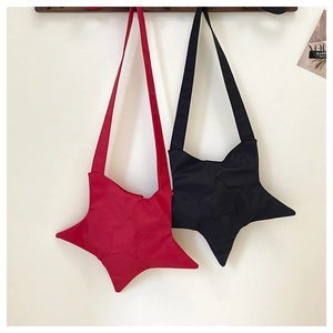 Detailed view of red and black star-shaped canvas crossbody bags with wide straps