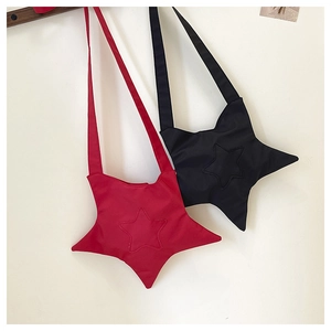Detailed view of red and black star-shaped canvas crossbody bags hanging on a wall