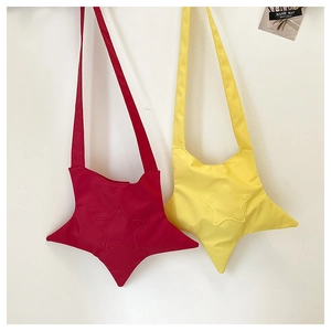 Close-up of cute star-shaped crossbody bags in yellow and red durable canvas material