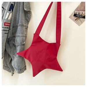 Close-up of a bright red star-shaped crossbody bag with durable woven nylon fabric