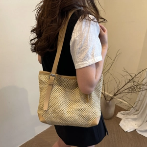 Summer straw woven tote bag with leather trim and adjustable straps for beach vacations