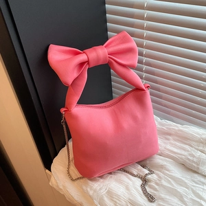 Pink satin handbag with a large bow handle and silver chain strap for women
