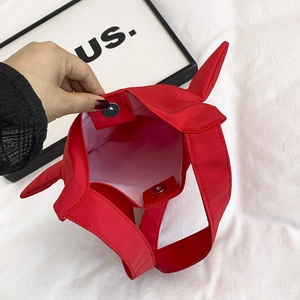 Red fabric handbag with star-shaped ears, interior compartment and magnetic buckle closure