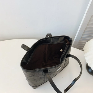 Black faux leather tote bag with cartoon dog embossing and large inner compartment