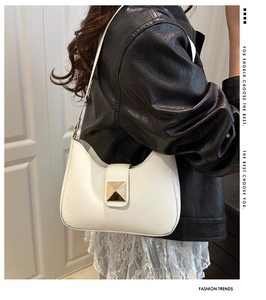 Chic white leather crescent underarm bag with gold metal buckle shown on a model