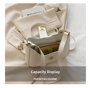 Top view of the interior capacity of a cream shoulder bag showing phone and long wallet