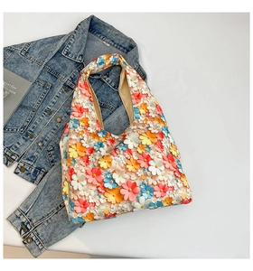 Detail of colorful 3D fabric flower petals on a summer tote bag with a high-capacity design