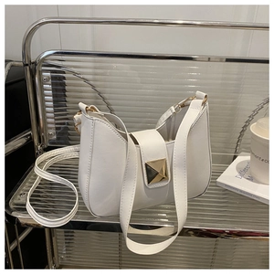 Close-up of minimalist white leather crescent underarm bag with gold metal buckle