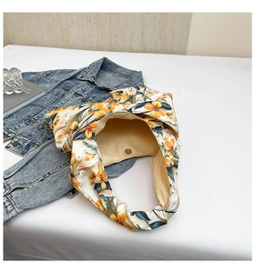 Detail of floral tote bag with oversized bow and magnetic metal buckle closure