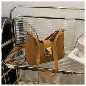 Detail of caramel crescent underarm bag with square gold-tone mirror buckle hardware