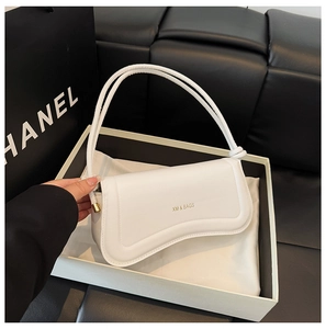 Close-up of white curved underarm bag in PU leather with gold lettering and adjustable strap
