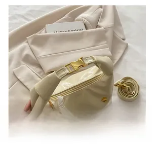 Detail of off-white PU leather handbag with gold buckle and pearl lace bow charm