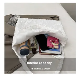 Detail view of the white tote bag spacious interior showing storage for daily essentials