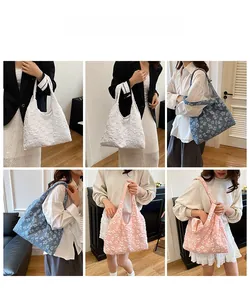 Lace tote bag with 3D floral texture shown in off-white, blue, and pink colors