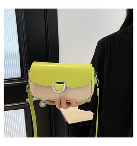 Detailed shot of yellow faux leather and woven texture mix bag with silver D-ring