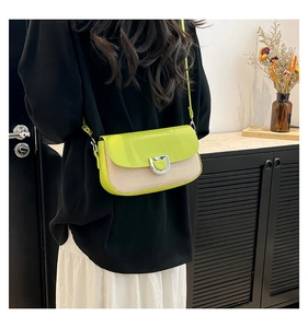 Detail of lime green flap crossbody bag with beige woven body and silver D-ring buckle