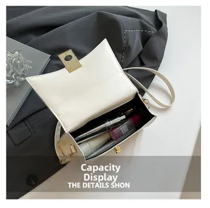 Interior view of white leather crossbody bag showing capacity for phone and cosmetics