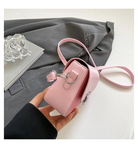 Close-up of pink crossbody bag featuring red mesh patchwork and silver metal buckle