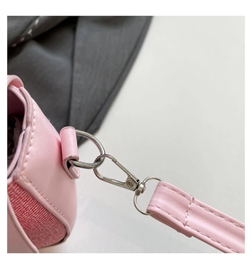 Detailed close-up of premium silver metal hardware and fine stitching on a pink leather bag