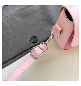 Close-up of pink PU leather shoulder bag with silver hardware and fine stitching detail