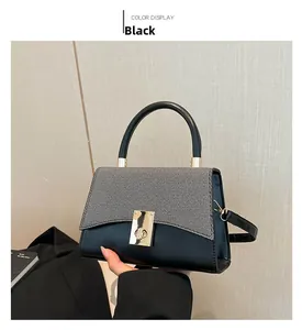 Detail of contrast stitching, gray twill texture and golden square twist lock on small handbag