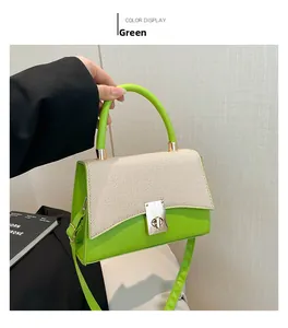 Close-up of vibrant green small square bag with woven texture and gold metal twist lock