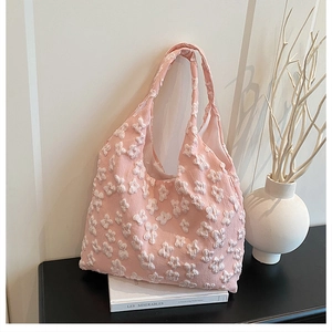 Detail of pink floral lace tote bag featuring 3D texture and wide integrated handles