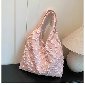Detailed close-up of pink tote bag with white floral 3D embroidery and soft fabric texture