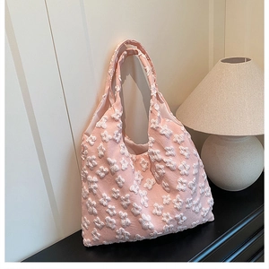 Close-up of pink tote bag featuring 3D white floral lace embroidery and soft texture