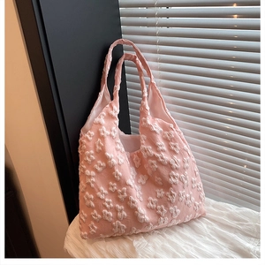 Detailed close-up of pink tote bag featuring 3D floral texture and bubble fabric finish