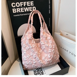 Detail shot of pink lace tote bag with white 3D flower embroidery and inner lining