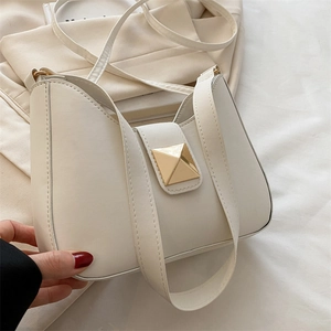 Minimalist cream white saddle shoulder bag with elegant gold square buckle detail