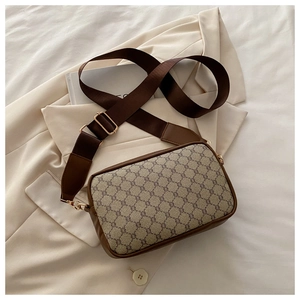 Detail of vintage beige monogram canvas cross-body bag with brown leather trim